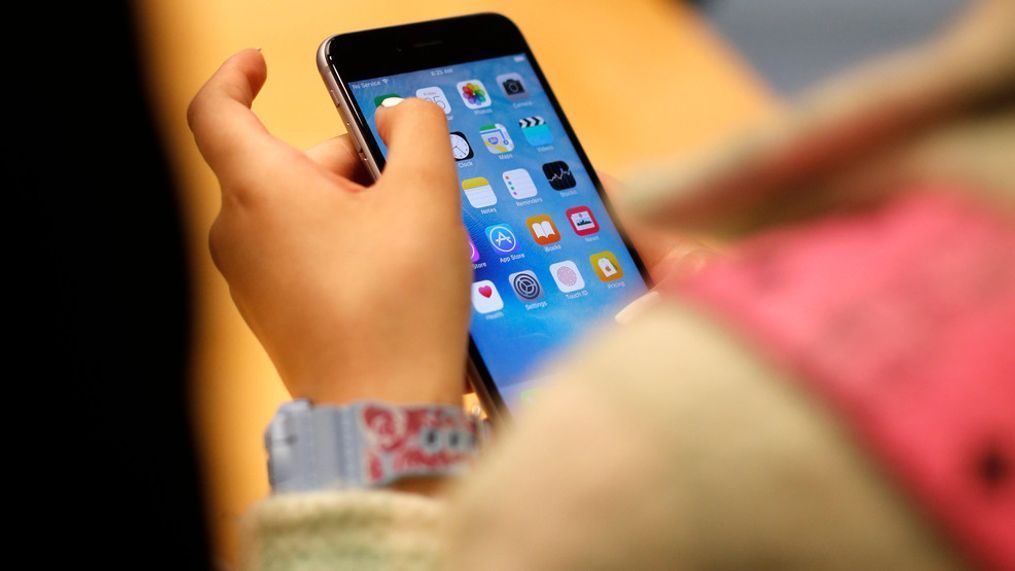 FILE - A child holds an iPhone at an Apple store on Sept. 25, 2015 in Chicago. (AP Photo/Kiichiro Sato, File)