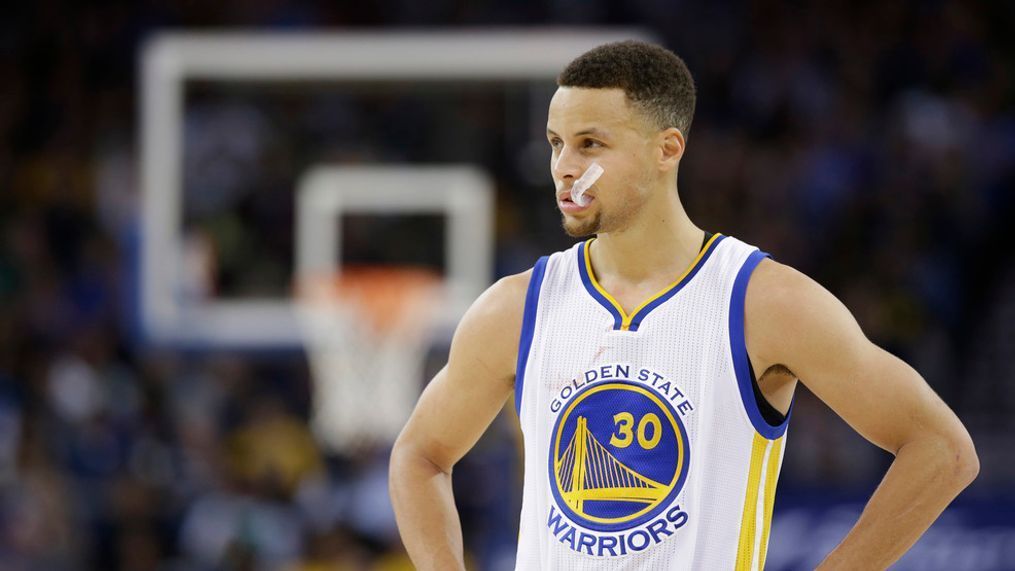 In this Friday, April 1, 2016 photo, Golden State Warriors' Steph Curry (30) pauses during an NBA basketball game against the Boston Celtics in Oakland, Calif. Though he moved on to the NBA long ago, March Madness is also Curry's world now. (AP Photo/Marcio Jose Sanchez)