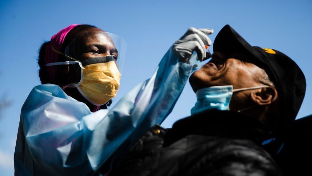 Dr. Ala Stanford administers a COVID-19 swab test on Wade Jeffries in the parking lot of Pinn Memorial Baptist Church in Philadelphia, Wednesday, April 22, 2020. (AP Photo/Matt Rourke)