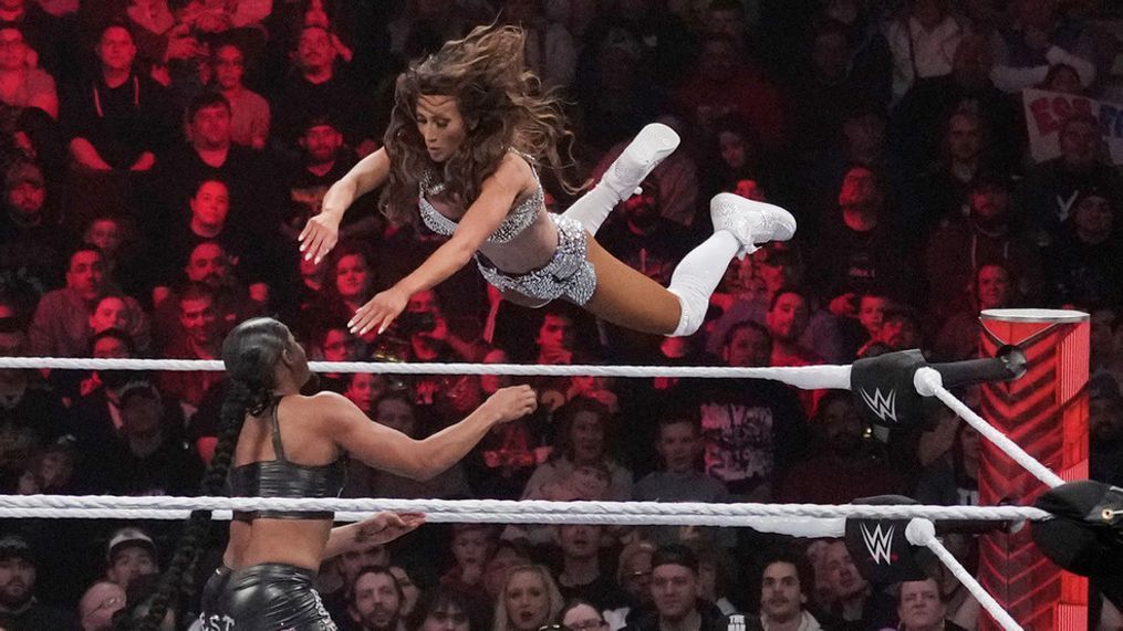 File - Wrestler Carmella leaps at Bianca Belair, during the WWE Monday Night RAW event, March 6, 2023, in Boston. (AP Photo/Charles Krupa, File)