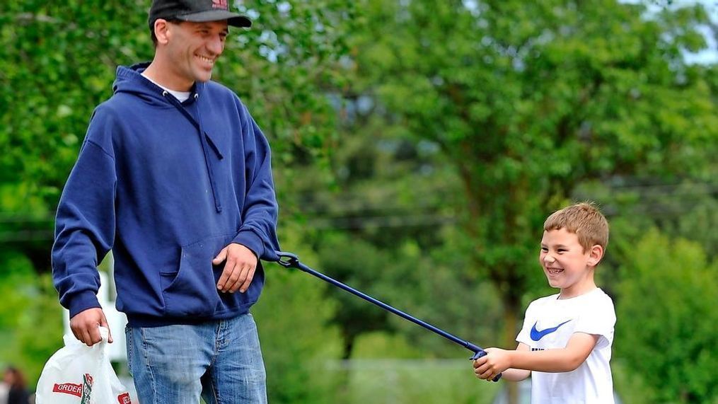 Cameron Gratta, 5, and his dad, John Gratta, pick up garbage at Fichtner-Mainwaring Park in Medford.