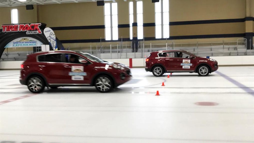 Two all-wheel-drive Kia Sportages accelerate during winter tire driving experiment. The car on the right has winter tires and can accelerate and stop faster than the car on the left, which has all-season tires. (Sinclair Broadcast Group / Jill Ciminillo){p}{/p}