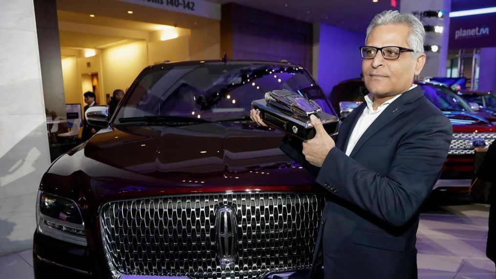 In this file photo, Kumar Galhotra, group vice president for Lincoln stands next to the 2018 Lincoln Navigator after the vehicle won truck of the year during the North American International Auto Show in Detroit. Ford Motor Co. said Thursday, Feb. 22, that it is naming Galhotra as a replacement for Raj Nair, the president for North America who was ousted this week over allegations of inappropriate behavior. Galhotra will take over on March 1. (AP Photo/Carlos Osorio, File)