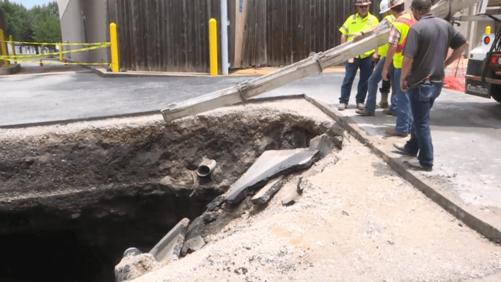 On Friday, crews filled in the sinkhole that opened up in the parking lot of a Chattanooga-area Walgreens, but the question remains - what caused its collapse? (Image: WTVC)