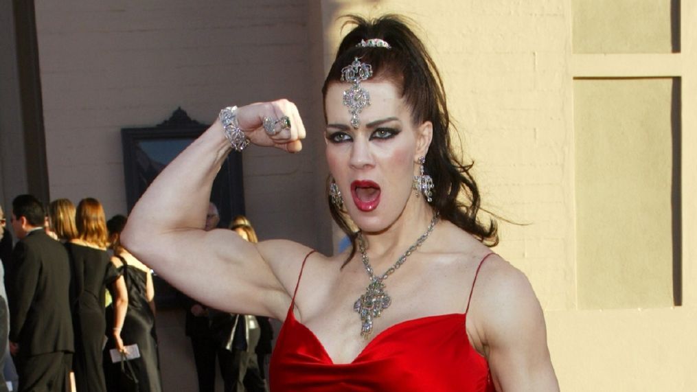 FILE - In this Nov. 16, 2003 file photo, Joanie Laurer, former pro wrestler known as Chyna, flexes her bicep as she arrives at the 31st annual American Music Awards, in Los Angeles. (AP Photo/Kevork Djansezian, File)