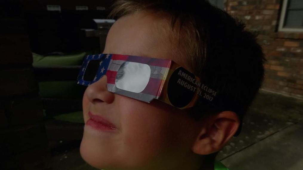 FILE - A boy wears CE-certified, ISO-approved solar eclipse glasses. (Walmart)