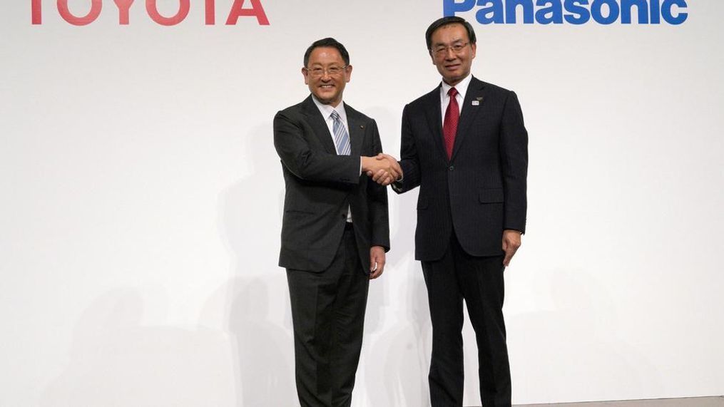 FILE - In this Dec. 13, 2017, file photo, Toyota Motor Corporation President Akio Toyoda, left, and Panasonic Corporation President Kazuhiro Tsuga, right, pose for photographers after a joint press conference in Tokyo. Toyota Motor Corp. and Panasonic Corp. said in a joint statement Tuesday, Jan. 22, 2019, they are setting up a joint venture to research, manufacture and sell batteries for ecological autos, an increasingly lucrative sector amid concerns about global warming. (AP Photo/Eugene Hoshiko, File)