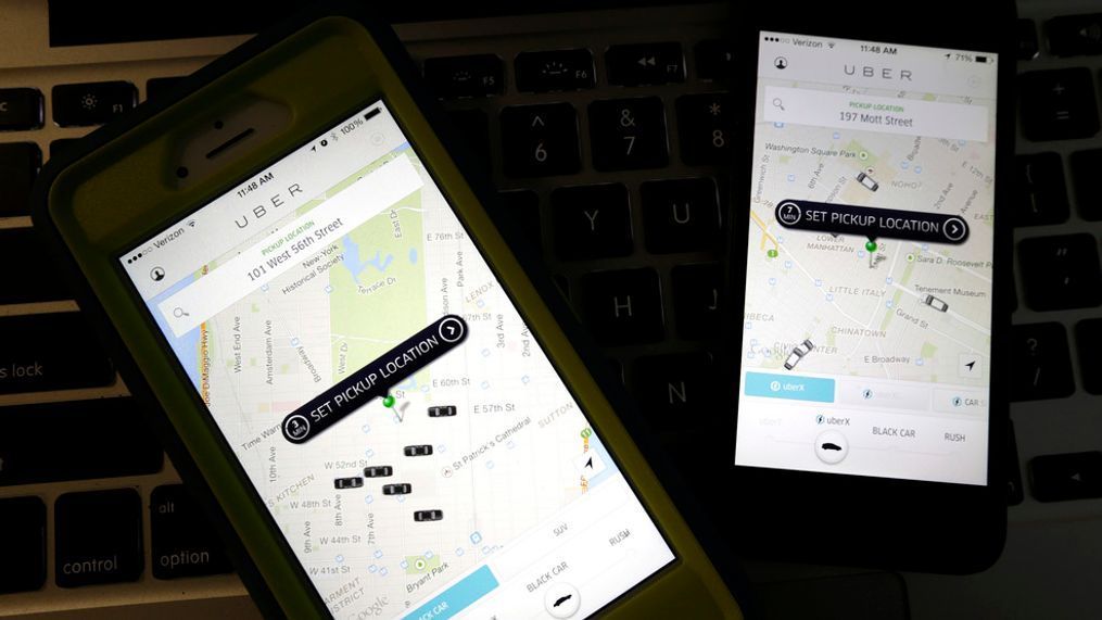 FILE - This Friday, Nov. 21, 2014, file photo taken in Newark, N.J., shows smartphones displaying Uber car availability in New York. (AP Photo/Julio Cortez, File)