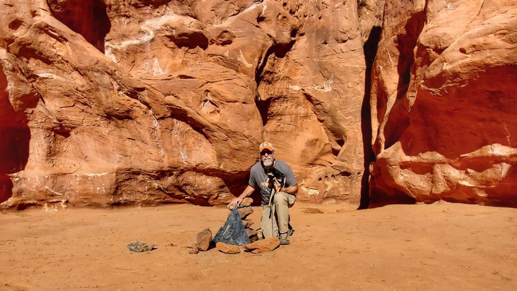 A man next to the spot that held the world-famous Utah monolith, now removed. (Photo: Canyon State Overland)