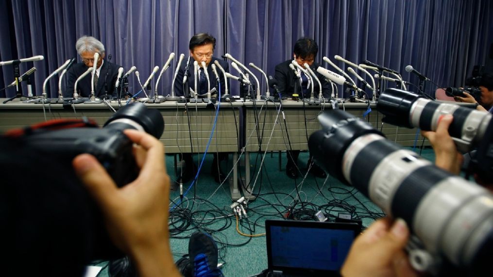 Mitsubishi Motors President Tetsuro Aikawa, center, listens to a reporter's question during a press conference in Tokyo, Wednesday, April 20, 2016. Mitsubishi Motors Corp. said Wednesday it used improper testing methods to make some of its vehicle models look more fuel efficient than they actually are. (AP Photo/Shizuo Kambayashi)