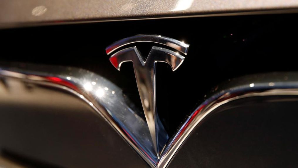 This file photo shows a Tesla emblem at the Auto show in Paris. Shares of Tesla Inc. soared Tuesday, Oct. 23. (AP Photo/Christophe Ena, File)