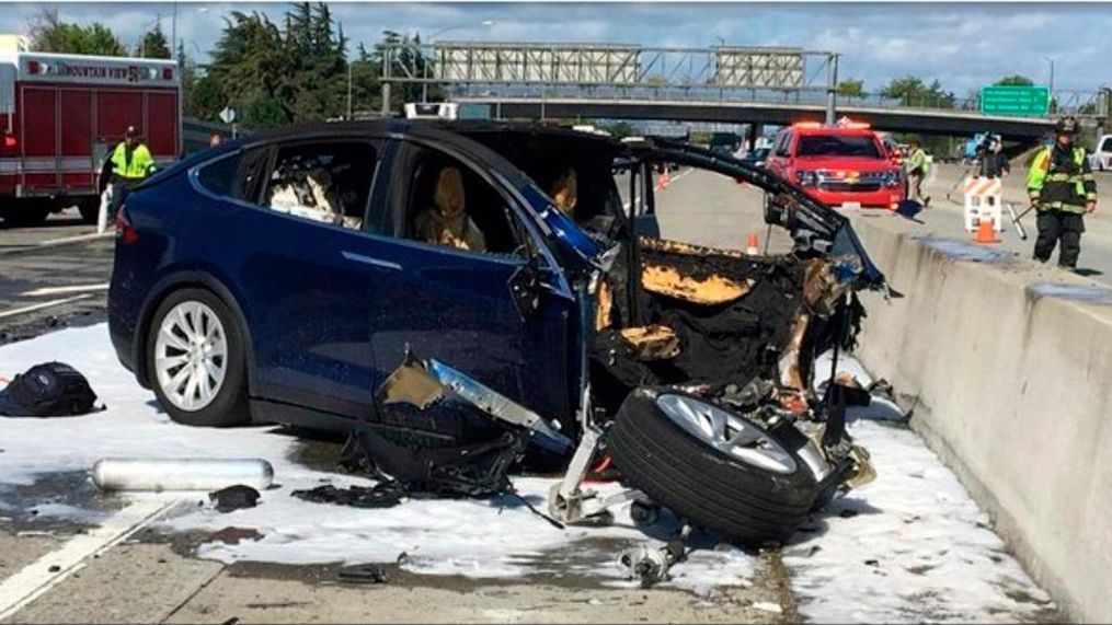 FILE - In this March 23, 2018 file photo provided by KTVU, emergency personnel work a the scene where a Tesla electric SUV crashed into a barrier on U.S. Highway 101 in Mountain View, Calif. The test results by AAA released Thursday, Nov. 15, 2018, come after several highly publicized crashes involving Tesla vehicles that were operating on the company's system named "Autopilot." The National Transportation Safety Board is investigating some of the crashes, including the March fatality that involved a Model X that struck a freeway barrier. (KTVU via AP, File)