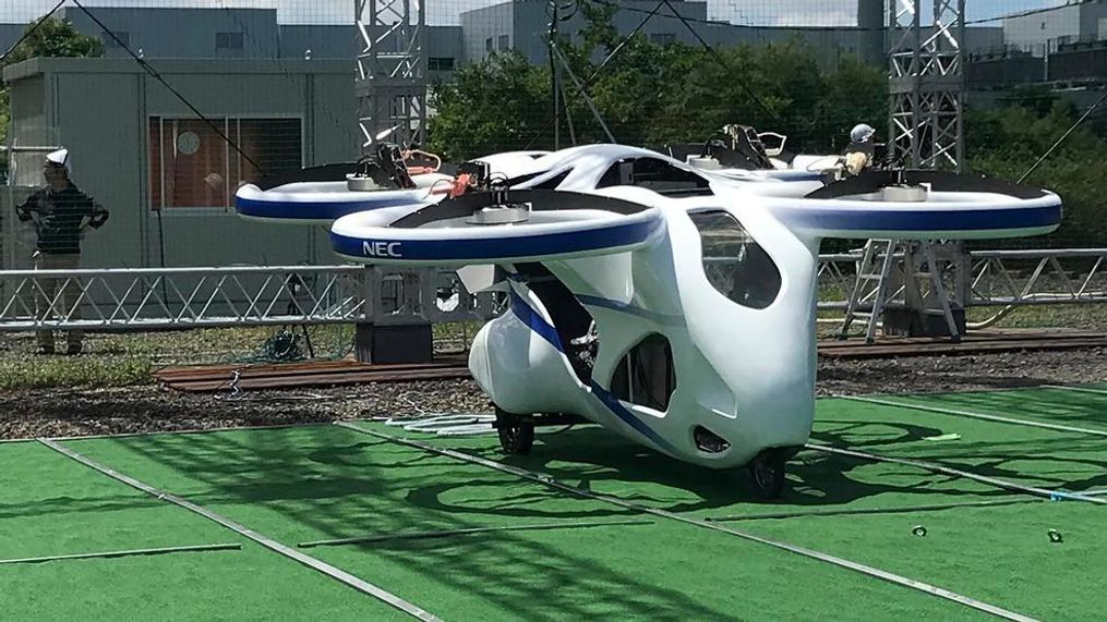 NEC Corp.'s machine with propellers is seen at a facility in Abiko, near Tokyo, before its test flight, Monday, Aug. 5, 2019. The Japanese electronics maker has shown a "flying car," a large drone-like machine with four propellers that hovered steadily for about a minute. The test flight Monday reaching 3 meters (10 feet) high was held in a gigantic cage, as a safety precaution.(AP Photo/Yuri Kageyama)