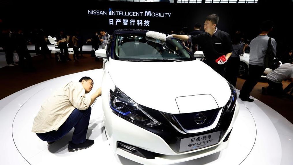 A visitor takes a closer look at the Sylphy Zero Emission during the start of the Auto China 2018 in Beijing, China, Wednesday, April 25, 2018. Volkswagen and Nissan have unveiled electric cars designed for China at the Beijing auto show that highlights the growing importance of Chinese buyers for a technology seen as a key part of the global industry's future. (AP Photo/Ng Han Guan)