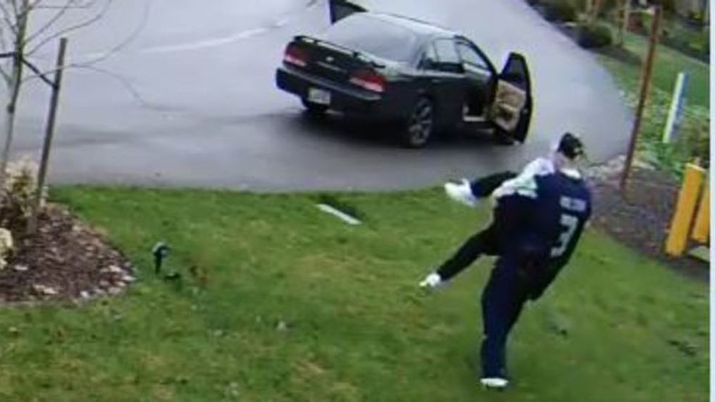 Screen capture from a home surveillance video showing a woman stealing packages slipping during her getaway (Photo via David Ababneh)