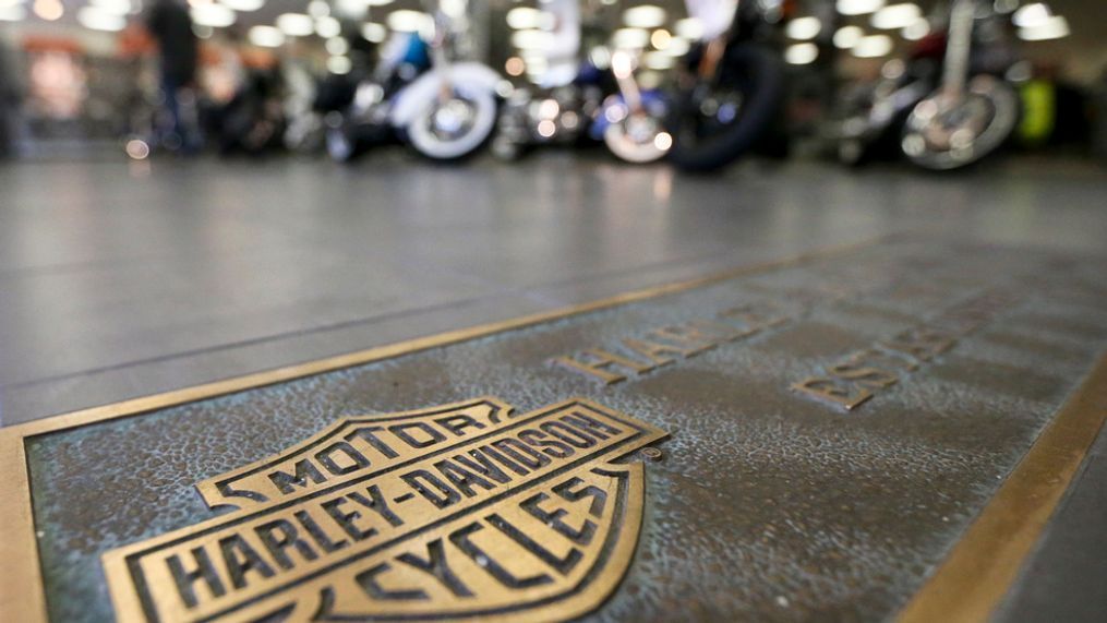 In this April 26, 2017, file photo, rows of motorcycles are behind a bronze plate with corporate information on the showroom floor at a Harley-Davidson dealership in Glenshaw, Pa. Harley-Davidson, facing rising costs from new tariffs, will begin shifting the production of motorcycles heading for Europe from the U.S. to factories overseas. (AP Photo/Keith Srakocic, File)