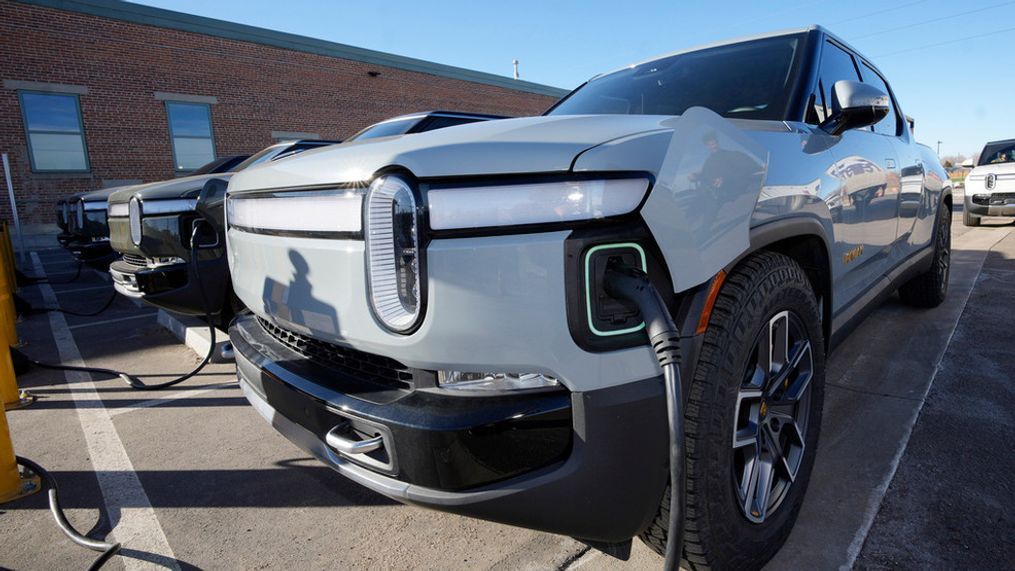 File - A 2023 R1T pickup truck is charged in a bay at a Rivian delivery and service center Wednesday, Feb. 8, 2023, in Denver. (AP Photo/David Zalubowski, File)