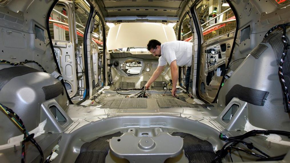 In this Dec. 21, 2006, file photo, an auto worker puts a wiring harness in an empty vehicle body during production of the General Motors' Chevrolet Equinox, Pontiac Torrent and the Suzuki XL7 at the CAMI Automotive facility in Ingersoll, Ontario, Canada. If President Donald Trump delivers on threats to slap 25 percent tariffs on imported automobiles and parts, experts say it will cut auto sales and cost jobs in the U.S., Canada and Mexico. It’s difficult to determine how large any price increases would be. But some back-of-the-envelope calculations show that a Chevrolet Equinox small SUV made in Canada could cost about $5,250 more in the U.S. (Dave Chidley/The Canadian Press via AP, File)