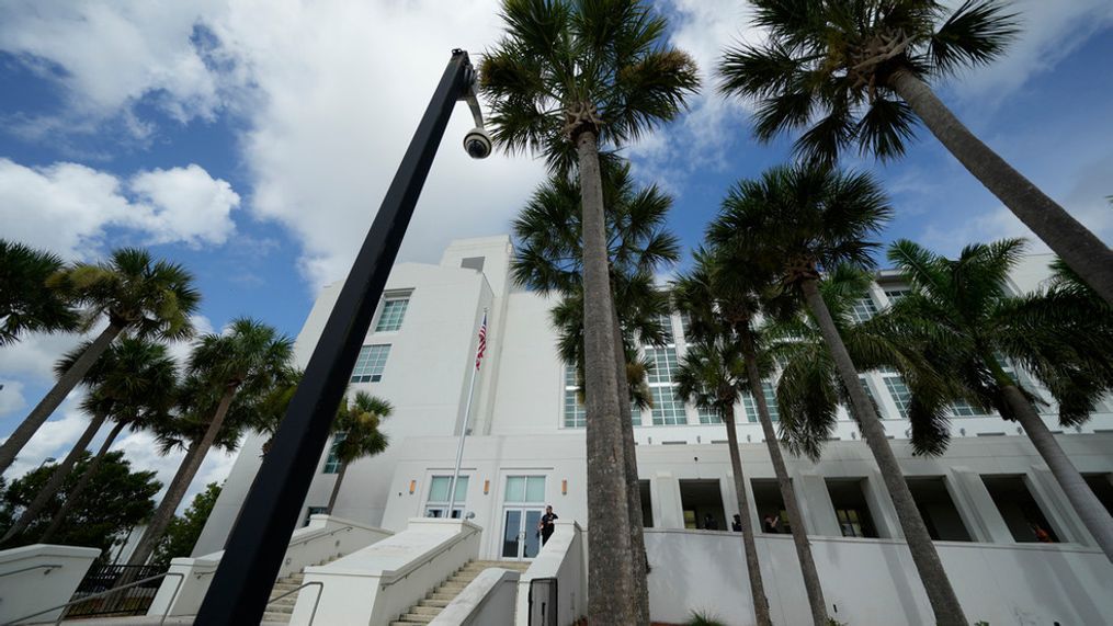 FILE - A police officer stands beside an entrance to the Alto Lee Adams Sr. U.S. Courthouse, Aug. 15, 2023, in Fort Pierce, Fla. The federal judge presiding over the classified documents case against former President Donald Trump is hearing arguments Friday, June 21, 2024, on a long-shot defense effort to get the indictment thrown out based on the claim that the prosecutor who brought the charges was illegally appointed. (AP Photo/Rebecca Blackwell, File)