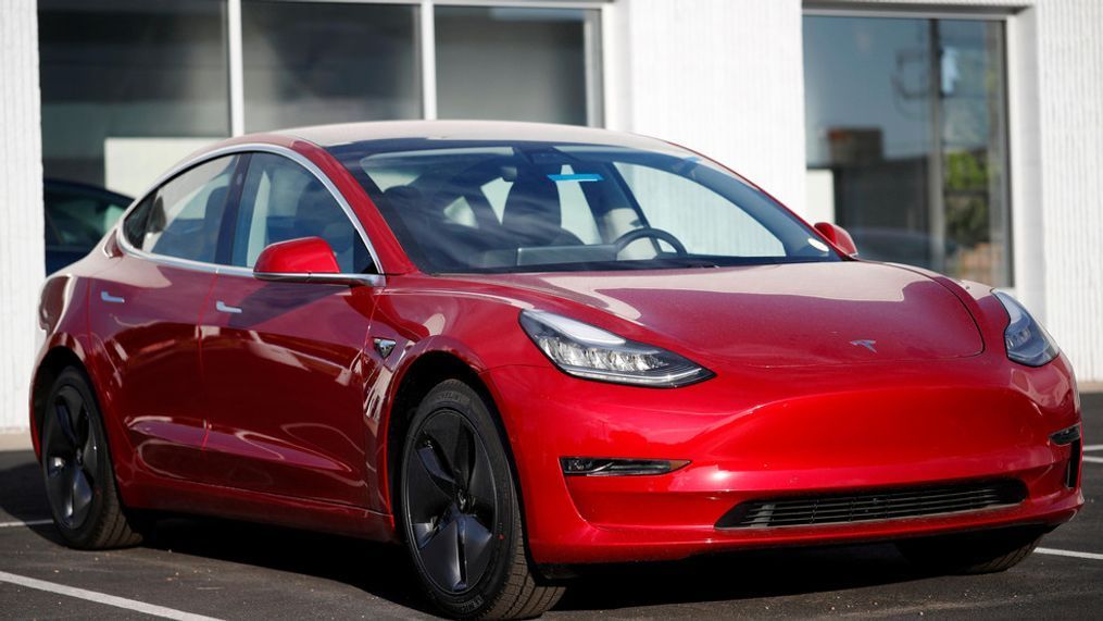 FILE- In this May 27, 2018, file photo, a 2018 Model 3 sedan sits at a Tesla dealership in Littleton, Colo. (AP Photo/David Zalubowski, File)