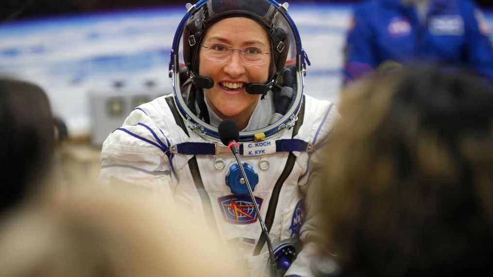 FILE - In this Thursday, March 14, 2019 file photo, U.S. astronaut Christina Koch, member of the main crew of the expedition to the International Space Station (ISS), speaks with her relatives through a safety glass prior the launch of Soyuz MS-12 space ship at the Russian leased Baikonur cosmodrome, Kazakhstan. (AP Photo/Dmitri Lovetsky, Pool)