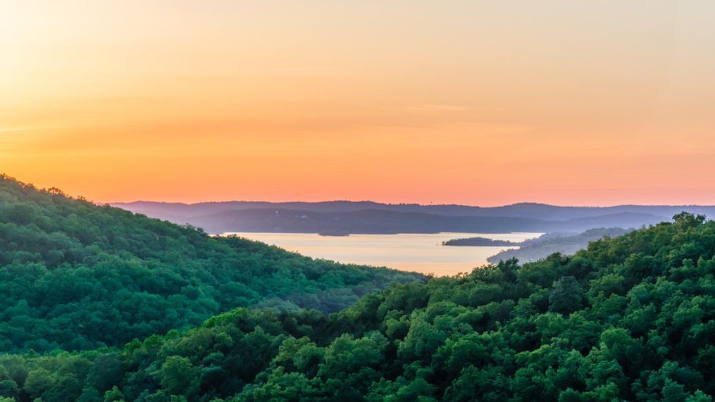 A colorful horizon overlooking Table Rock Lake in the Ozark Mountains at sunset.