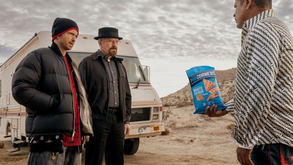 This photo provided by Frito-Lay shows Aaron Paul, Bryan Cranston and Raymond Cruz in scene from PopCorners 2023 Super Bowl NFL football spot.  Big name advertisers are paying as much as $7 million for a 30-second spot during the big game on Sunday, Feb. 12, 2023. In order to get as much as a return on investment for those million, most advertisers release their ads in the days ahead of the big game to get the most publicity for their spots. (Frito-Lay via AP)