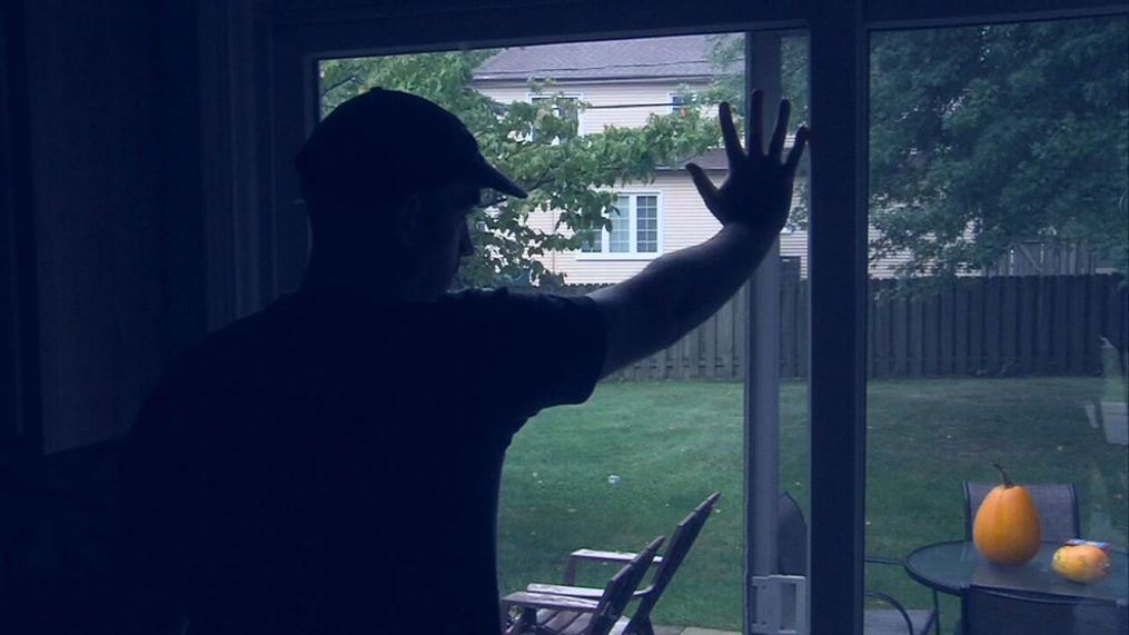 FILE - A man possibly suffering from seasonal affective disorder, or SAD, looks out of his home into the gray. (KOMO News file photo)