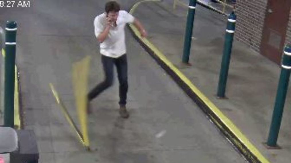 Man caught on camera damaging parking gate. (East Lansing Police Department)