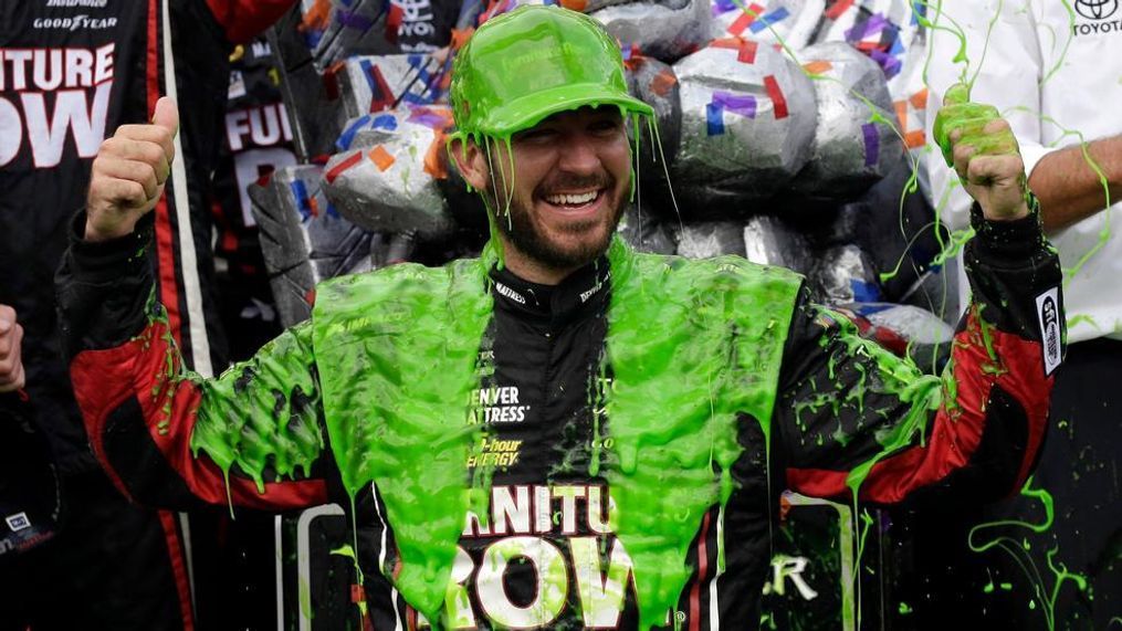 Martin Truex Jr. celebrates with his crew in Victory Lane after winning a NASCAR Cup Monster Energy Series auto race at Chicagoland Speedway in Joliet, Ill., Sunday, Sept. 17, 2017. (AP Photo/Nam Y. Huh)