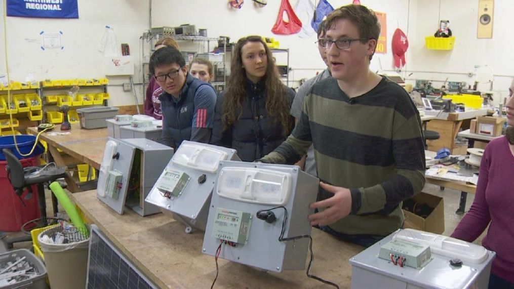 Catlin Gabel High School student Solomon Olshin and others show off their invention, the JuiceBox, which is meat to help give power to tiny homes for the homeless. (KATU Photo)