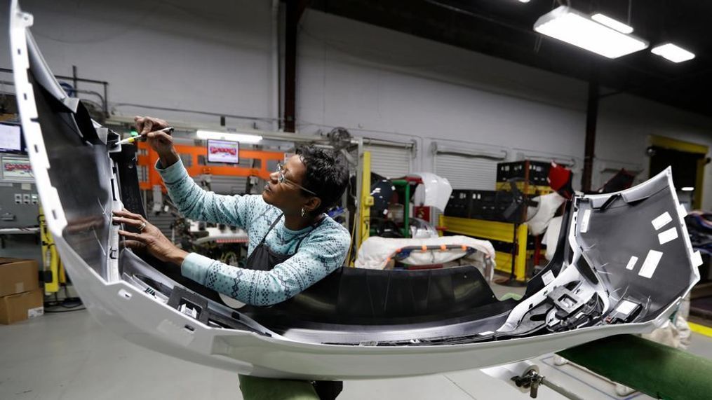 Final inspector Mary Skinner inspects the rear end of a General Motors Chevrolet Cruze at Jamestown Industries, Wednesday, Nov. 28, 2018, in Youngstown, Ohio. Jamestown Industries supplies parts for the Chevy Cruze. GM said Monday that Lordstown will stop making the Chevy Cruze by March, at a cost of 1,400 union jobs on top of the 2,700 lost there since President Donald Trump took office. (AP Photo/Tony Dejak)