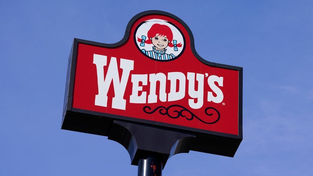 FILE - A sign stands over a Wendy's restaurant, Feb. 25, 2021, in Des Moines, Iowa.{&nbsp;} (AP Photo/Charlie Neibergall, File)