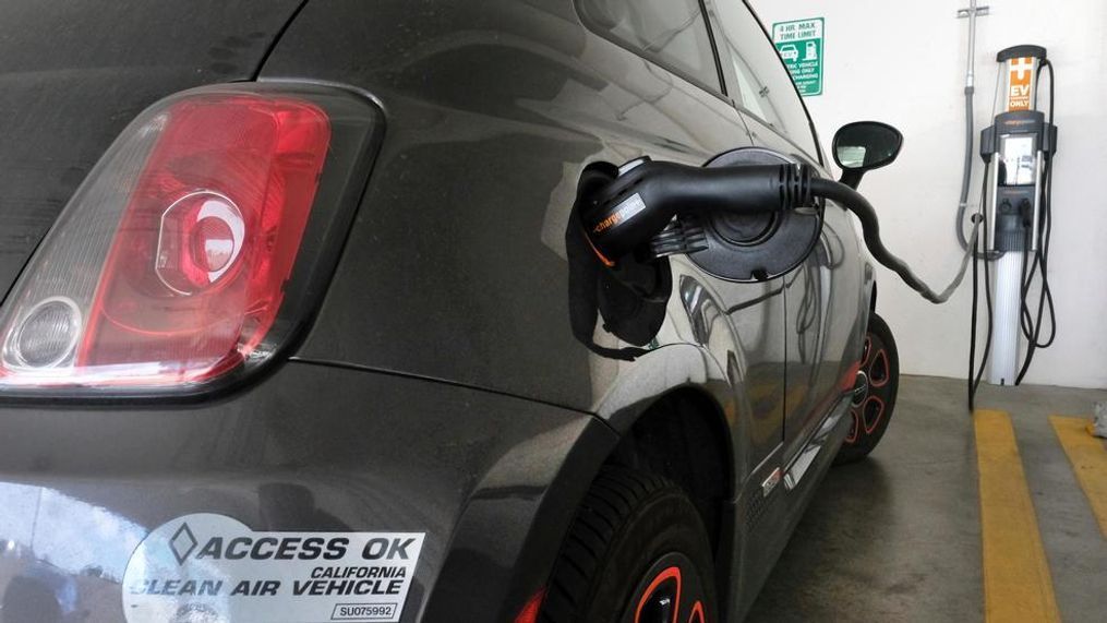 In this{&nbsp;} 2016 file photo, an electric Fiat plugged into a charging station in a parking lot in Los Angeles. California utilities will invest nearly $768 million to expand a network of charging stations and other infrastructure for electric vehicles as the state moves toward a goal of 5 million zero-emission cars on the roads by 2030. The California Public Utilities Commission voted 5-0 Thursday, May 31, 2018, to fund programs statewide, with an emphasis on building facilities in disadvantaged communities. (AP Photo/Richard Vogel, File)