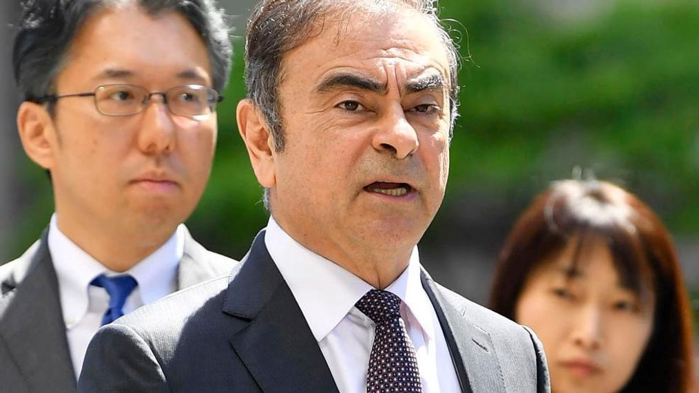 In this May 23, 2019, file photo former Nissan chairman Carlos Ghosn, center, arrives at Tokyo District Court for a pre-trial meeting in Tokyo.  Nissan has agreed to pay $15 million and its former chairman Carlos Ghosn is paying $1 million to settle federal regulators' civil fraud charges of hiding from investors more than $140 million in compensation and retirement benefits for Ghosn. (Ren Onuma/Kyodo News via AP, File)