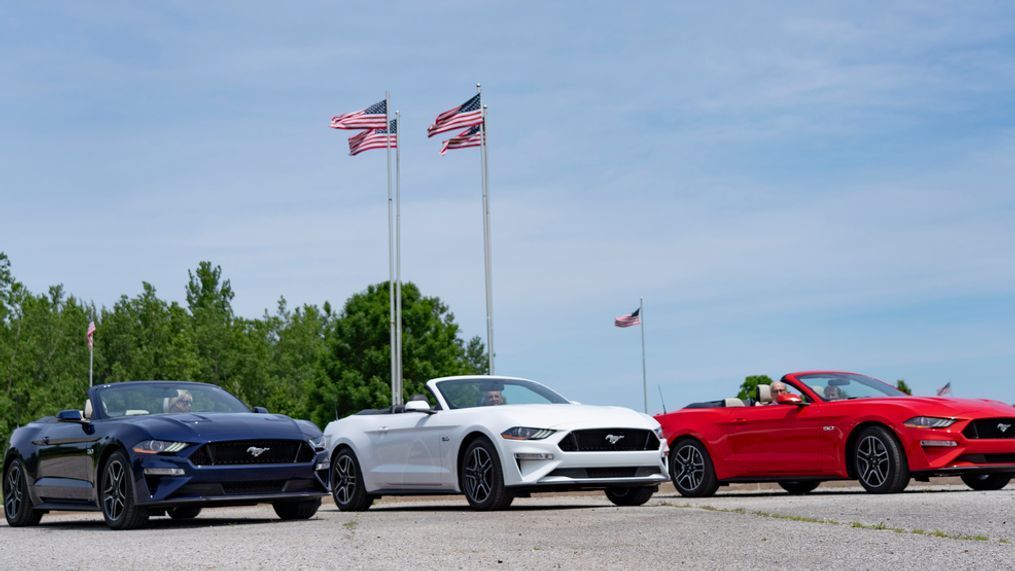 Ford retiree and Mustang enthusiast Kaywin Martin gives the gift of patriotism - in the form of red, white and blue Mustang GT convertibles - to his three children for his 80th birthday. (Image courtesy of Ford Motor Co.)
