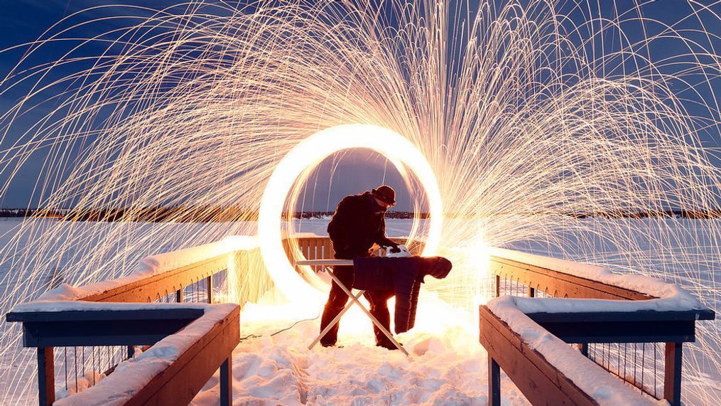 The shot that started it all for me. Paul Zizka irons in -25 degrees Celsius in Yellowknife, Northwest Territories. Friend Matt Hosford assisted behind with steel wool on a string to create the amazing fire effect. (Photo &amp; Caption: Jack Nichols)