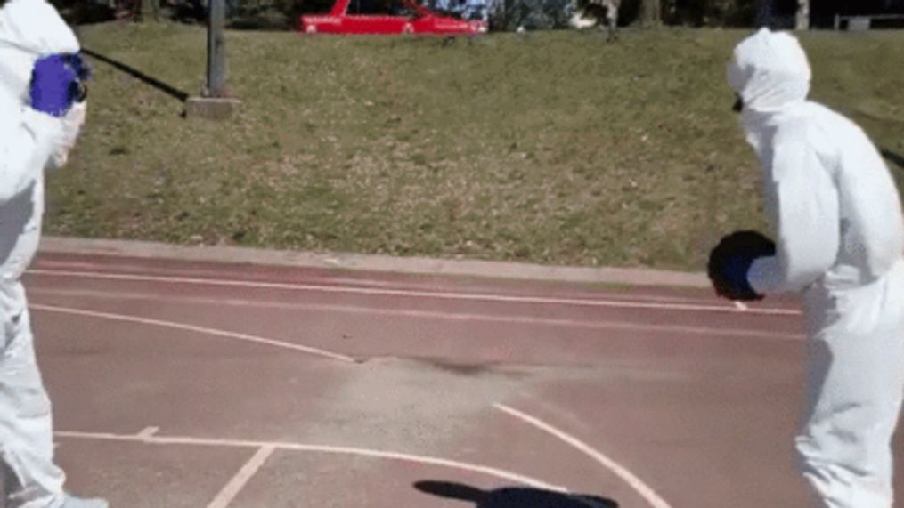 Teens wear hazmat suits for neighborhood basketball game (William Mayo via Storyful)