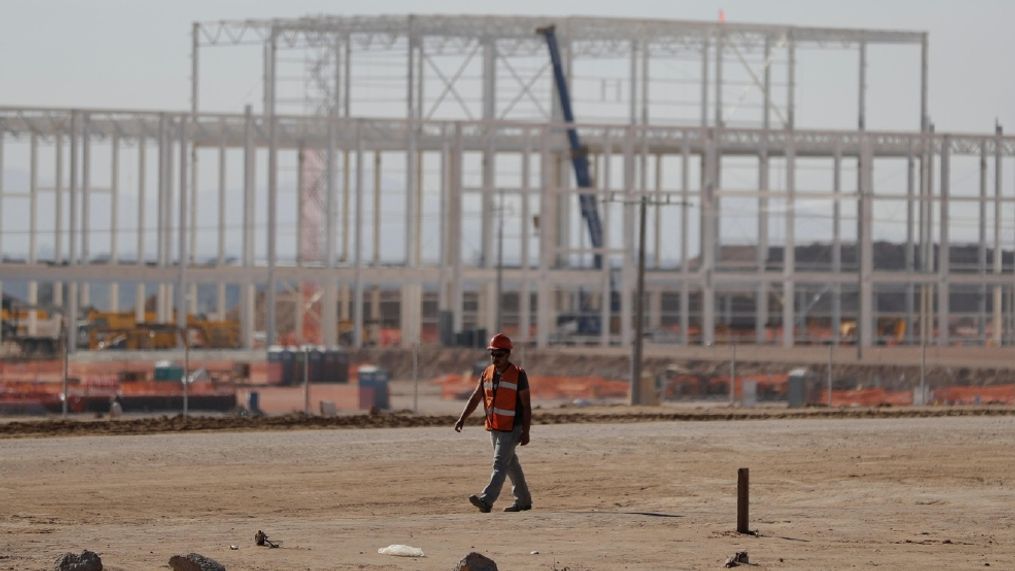 A man walks past the nearly deserted construction site, as workers shut down operations and remove equipment a day after Ford announced the cancellation of plans to build a $1.6 billion auto manufacturing plant on the site, in Villa de Reyes, outside San Luis Potosi, Mexico, Wednesday, Jan. 4, 2017. Ford's cancellation, which costs the region thousands of projected jobs, has sounded alarms throughout the country and sent Mexico's currency tumbling by nearly 1%. (AP Photo/Rebecca Blackwell)