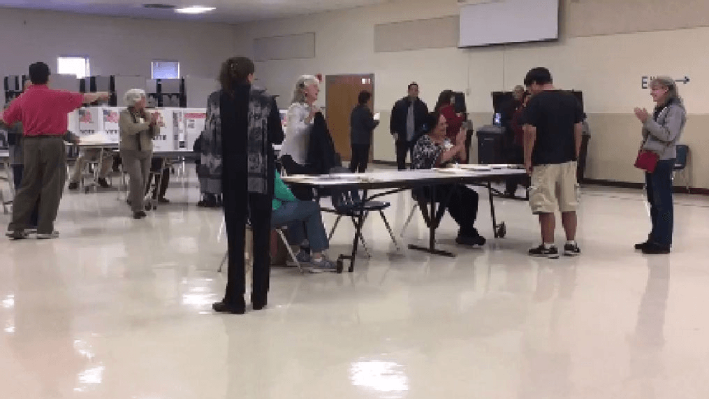 Volunteers ring cowbell each time first-time voters check in at Va. polling place. (WJLA/Mike Carter-Conneen)