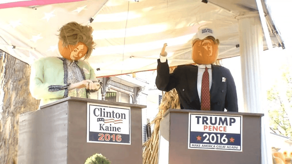 A new display at the Pumpkin House shows pumpkin representations of Donald Trump and Hillary Clinton at two podiums, complete with campaign signs and a hat for Trump. (WCHS/WVAH)