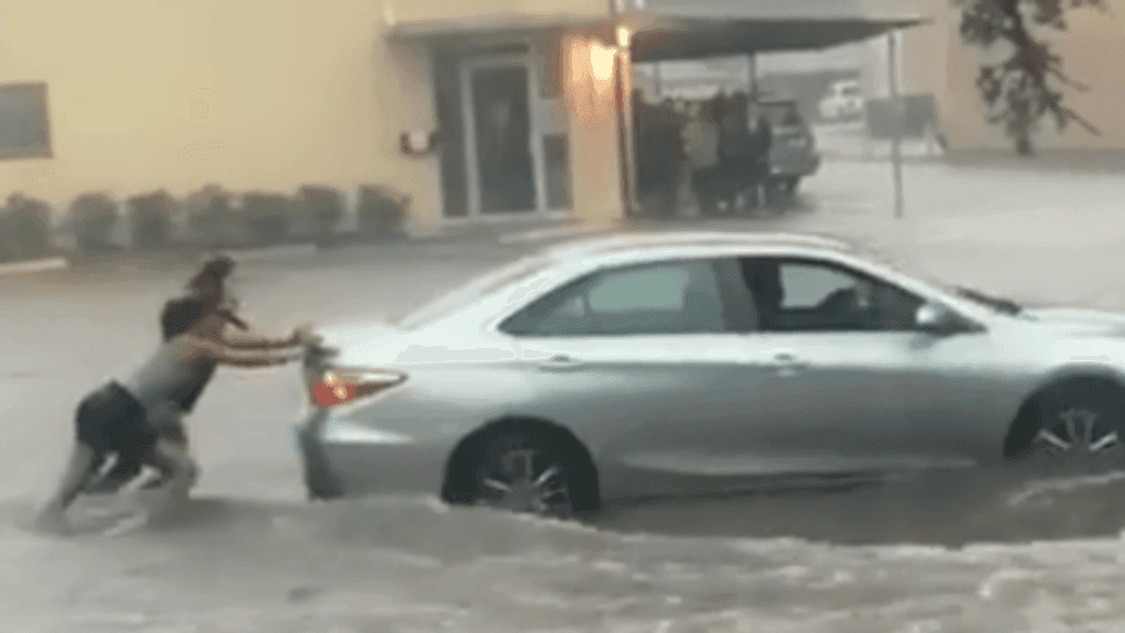 Women push stranded cars after Imelda floods Houston streets (Erika Maida via Storyful)