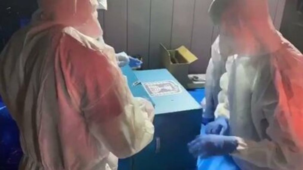 Israeli election officials in hazmat suits count ballots from quarantined voters (Israeli Central Elections Committee via Storyful)