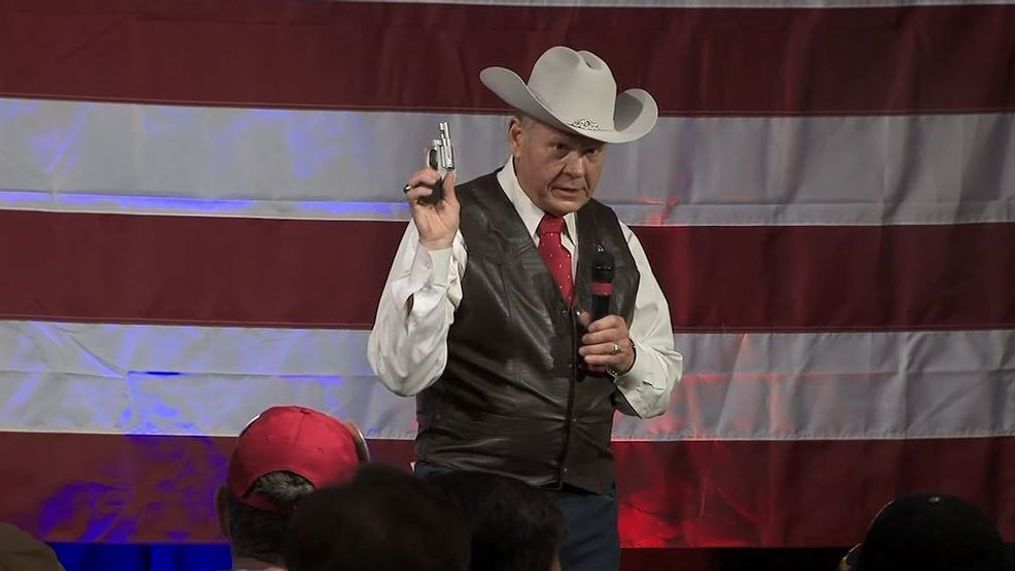 Republican&nbsp;Senate candidate Roy Moore pulls out a handgun during a campaign event, Monday, Sept. 25, 2017. (CNN Newsource)