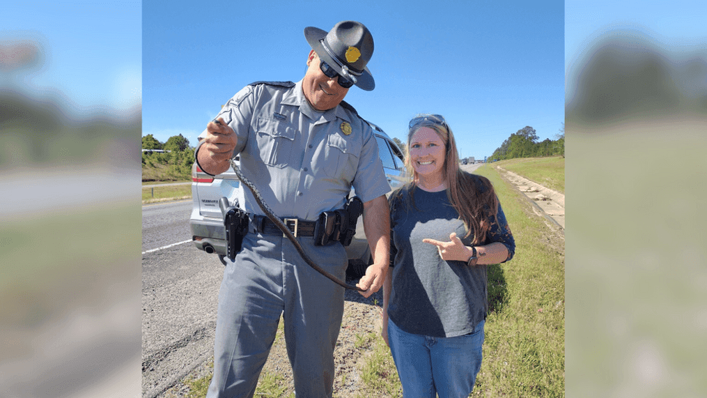 Sergeant Jonathan Oxandaboure helped Mary Alice Simmons get a snake out of her car in Kershaw County on Friday, September 8, 2023. (SCDPS)