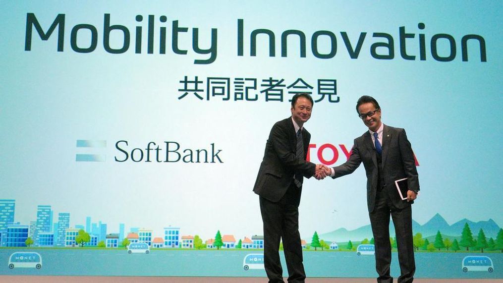 Representative Director and CTO of SoftBank Corp. Junichi Miyakawa, left and Executive Vice President of Toyota Motor Corporation Shigeki Tomoyama, right, shake hands during a press conference in Tokyo Thursday, Oct. 4, 2018. Japan’s No. 1 automaker Toyota Motor Corp. and Japanese technology giant SoftBank Group Corp. say they are setting up a joint venture to create mobility services. (AP Photo/Eugene Hoshiko)