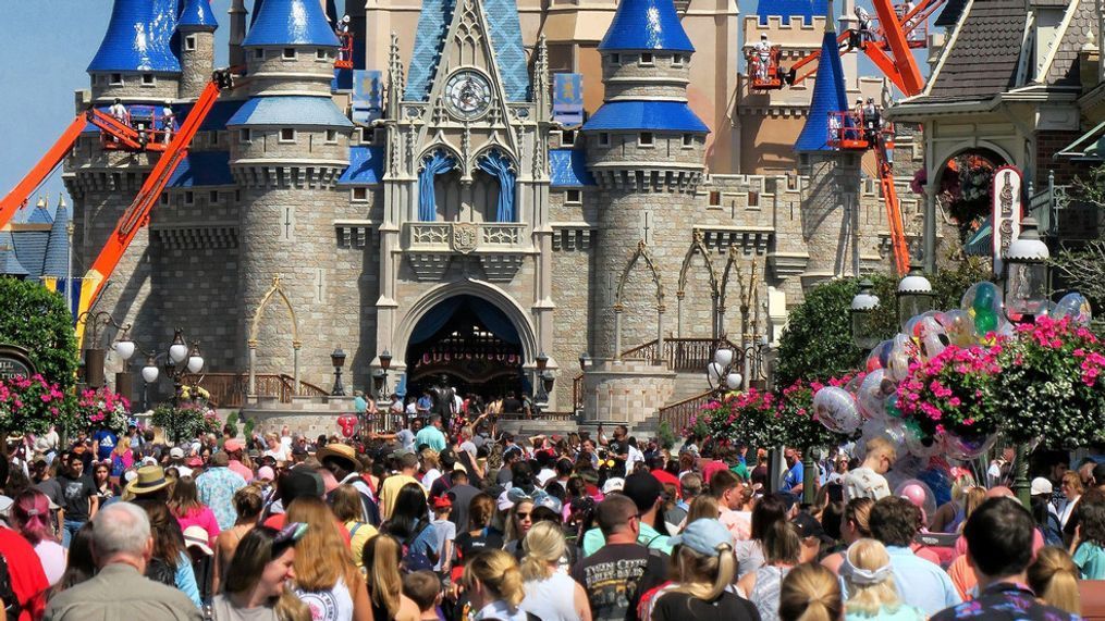 FILE - In this March 12, 2020, file photo, a crowd is shown along Main Street USA in front of Cinderella Castle in the Magic Kingdom at Walt Disney World in Lake Buena Vista, Fla. (Joe Burbank/Orlando Sentinel via AP, FIle)