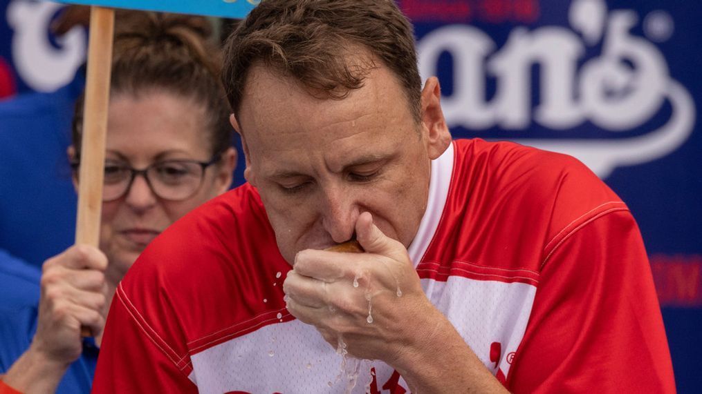 Joey Chestnut eats a hot dog as he competes for his 16th championship title during the 2023 Nathan's Famous Fourth of July hot dog eating contest in the Coney Island section of the Brooklyn borough of New York, Tuesday, July. 4, 2023. (AP Photo/Yuki Iwamura)