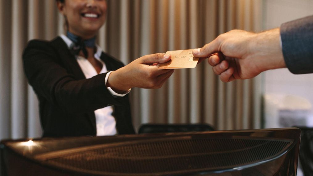 FILE - Close up of businessman paying with credit card at reception desk in hotel. (Getty Images)