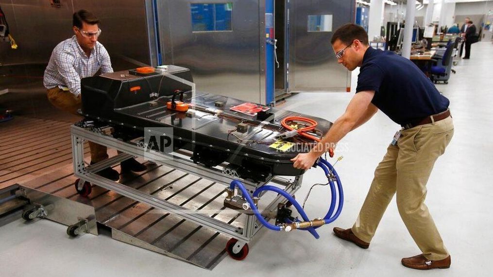 FILE- In this Nov. 4, 2016, file photo, a Chevrolet Bolt EV battery pack is removed for testing after undergoing charging and discharging cycles at General Motors Warren Technical Center's Advanced Energy Center in Warren, Mich. If U.S. consumers ever ditch fuel burners for electric vehicles, then the United Auto Workers union is in trouble. Gone would be thousands of jobs at engine and transmission plants across the industrial Midwest, replaced by smaller workforces at squeaky-clean mostly automated factories that mix up chemicals to make batteries. (AP Photo/Duane Burleson, File)